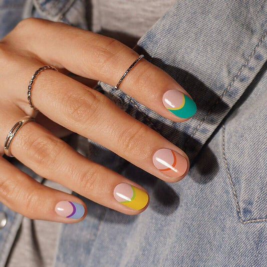 Colourful gel nail strips manicured being cured under UV/LED lamp