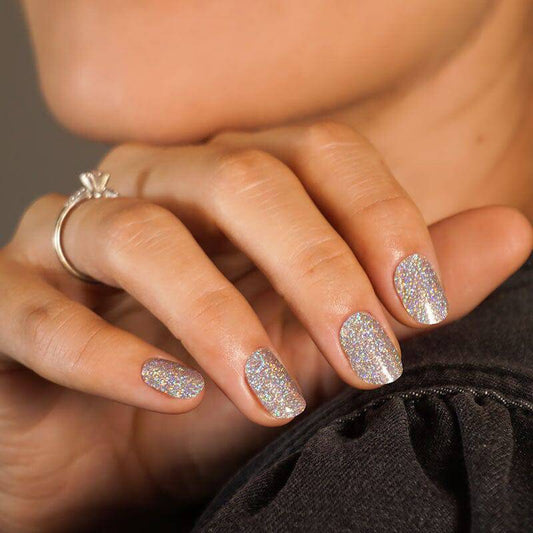 Colourful gel nail strips manicured being cured under UV/LED lamp