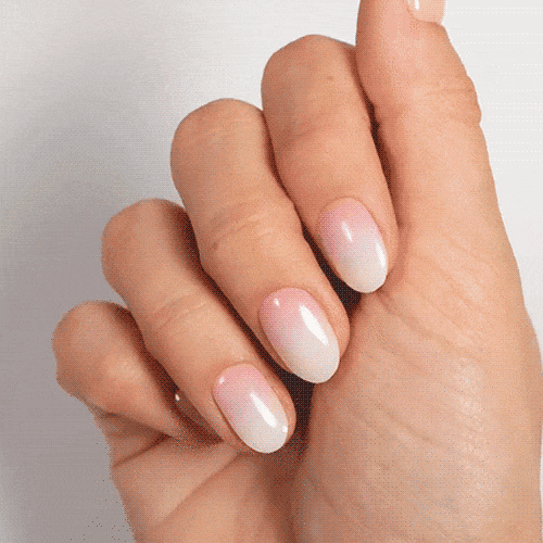 Natural pink gradient nails on a close-up hand