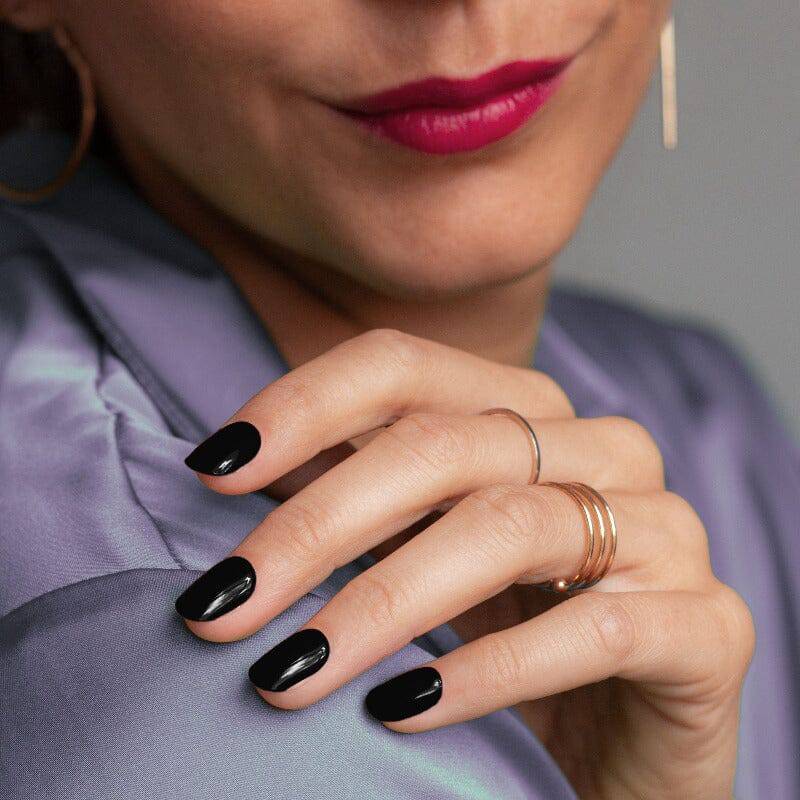 Glossy black manicure styled with a modern look