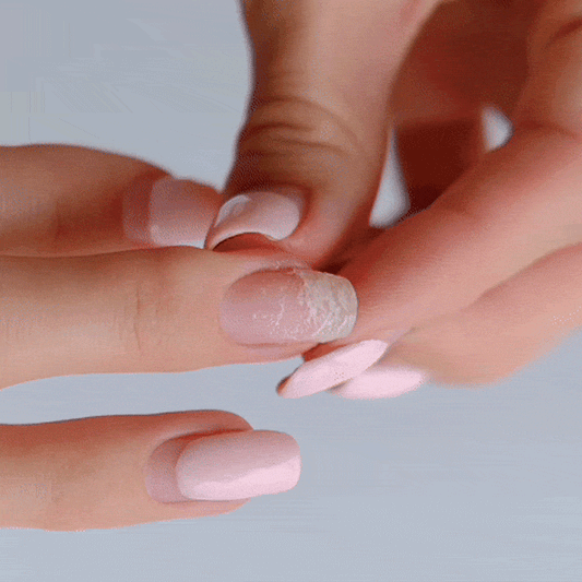 Colourful gel nail strips manicured being cured under UV/LED lamp