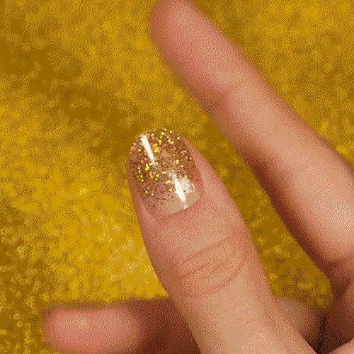 Colourful gel nail strips manicured being cured under UV/LED lamp