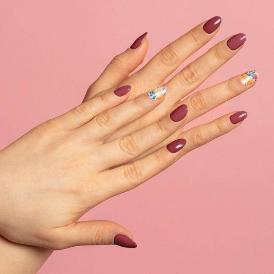 Colourful gel nail strips manicured being cured under UV/LED lamp