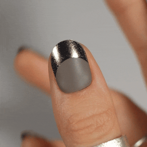 Colourful gel nail strips manicured being cured under UV/LED lamp