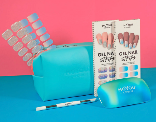 Colourful gel nail strips manicured being cured under UV/LED lamp