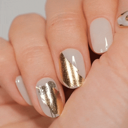 gold geometrical designs on gel polish stickers on pearl base coat 