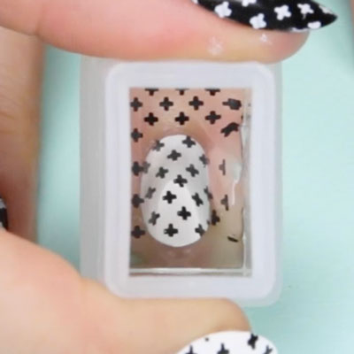 Nail stamping designs being applied to a nail with a stamper