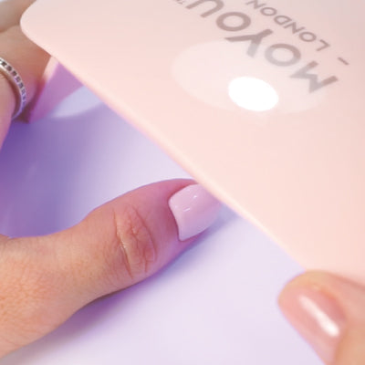 Curing MoYou London's Gel Nail Strips manicure with a UV/LED light