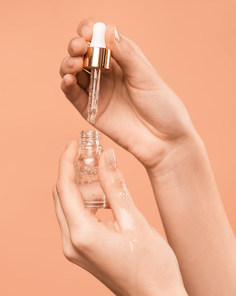 Hands holding nail cuticle oil